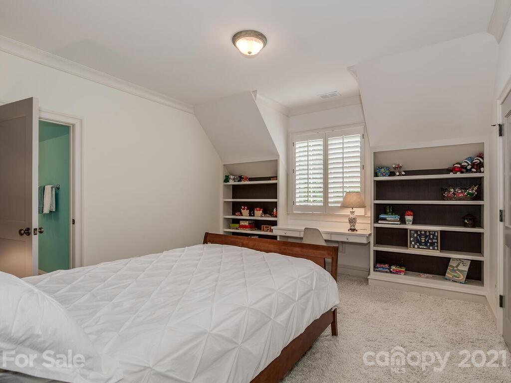 1056 Bolling Road Charlotte, NC 28207 - Photo 37 of 48 a bedroom with a bed and furniture