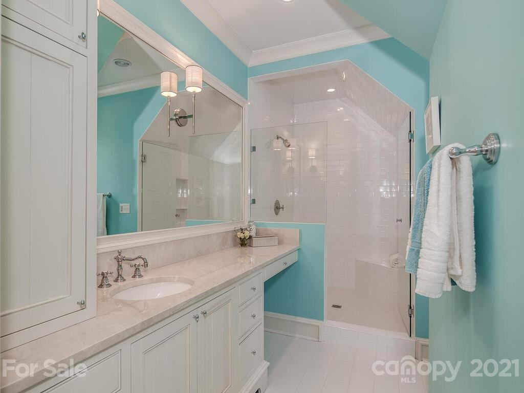1056 Bolling Road Charlotte, NC 28207 - Photo 38 of 48 a bathroom with a double vanity sink mirror and shower