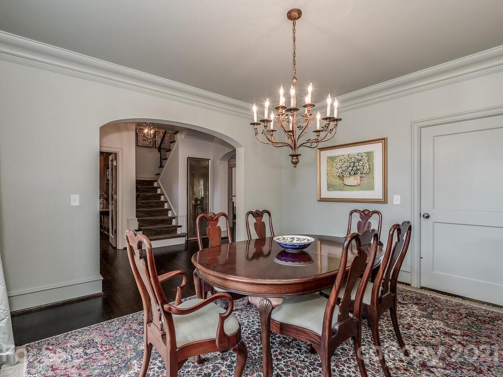 1056 Bolling Road Charlotte, NC 28207 - Photo 10 of 48 a view of a dining room with furniture and chandelier