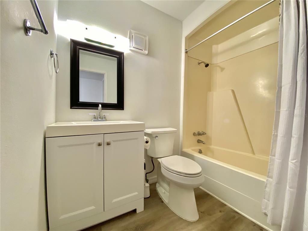 6519 West Newberry Road, Unit 1211 Gainesville, FL 32605 - Photo 9 of 10 a bathroom with a toilet sink and a mirror