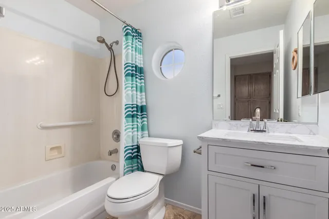 a bathroom with a toilet sink and shower