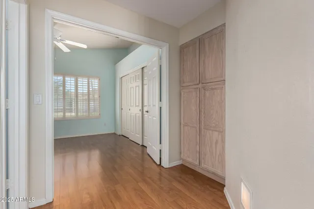 an empty room with wooden floor and a bathroom