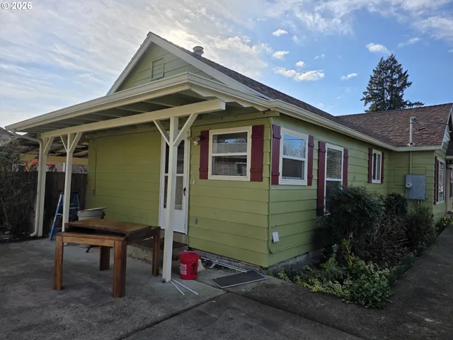 a front view of a house with plants