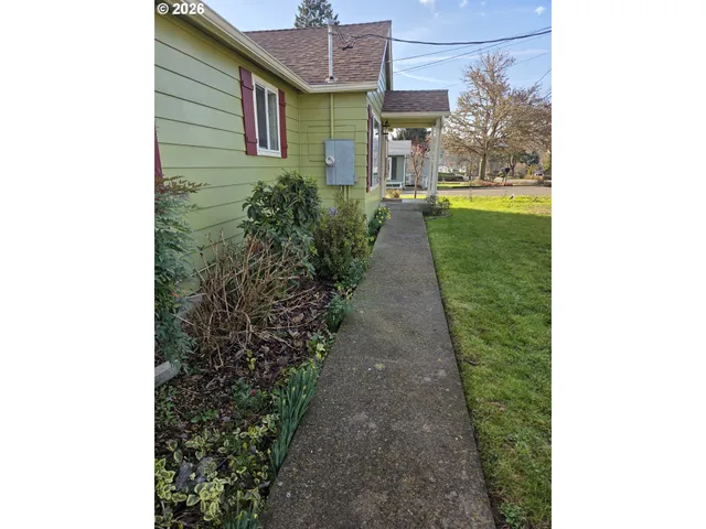 a pathway of a house with a yard