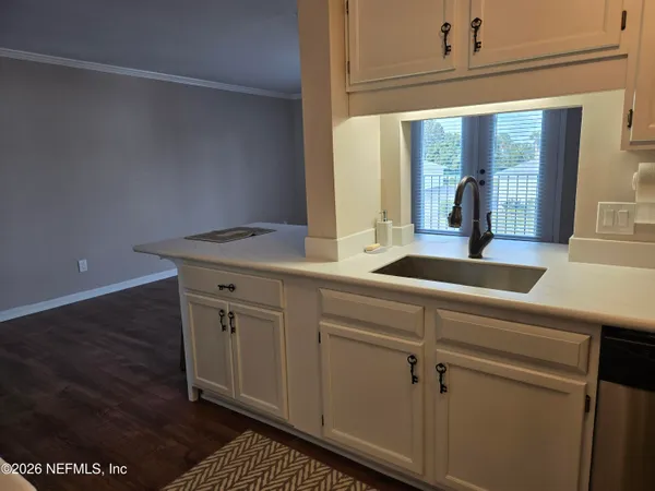 a kitchen with stainless steel appliances a stove a microwave and sink
