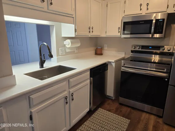 a kitchen with stainless steel appliances a refrigerator stove and sink