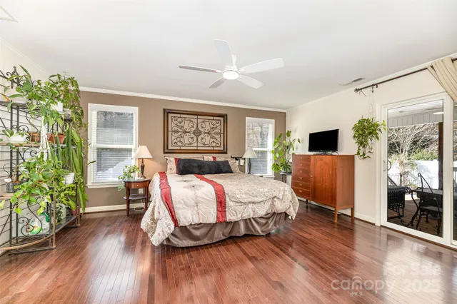 a spacious bedroom with a bed and a wooden floor