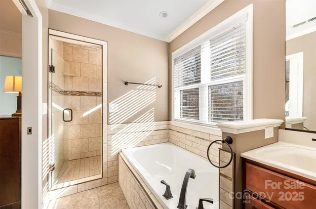 a bathroom with a tub sink and window