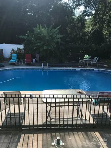 a view of a roof deck with table and chairs