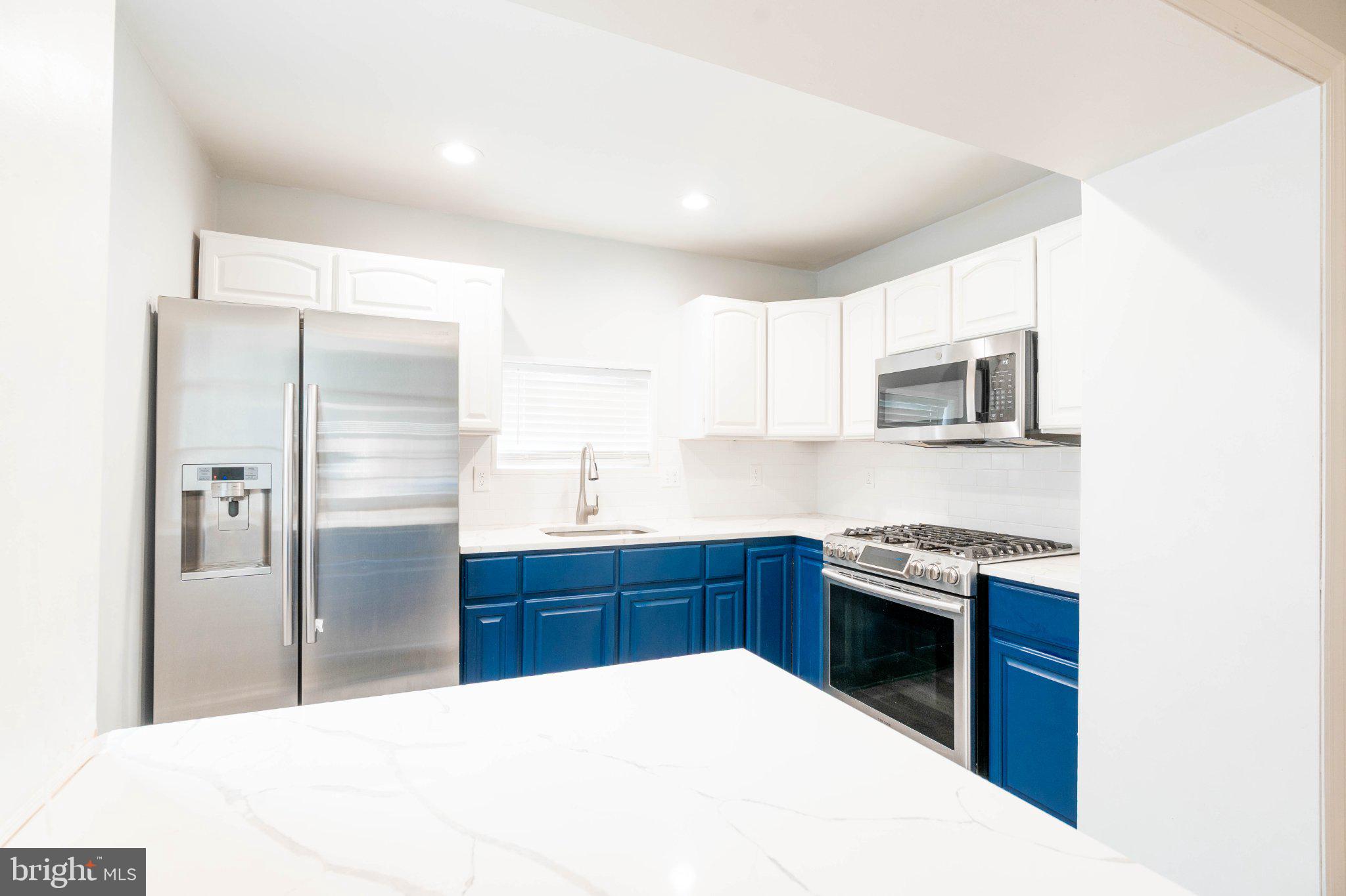 2433 South 3rd Street Philadelphia, PA 19148 - Photo 7 of 25 Modern kitchen with vibrant blue accents.