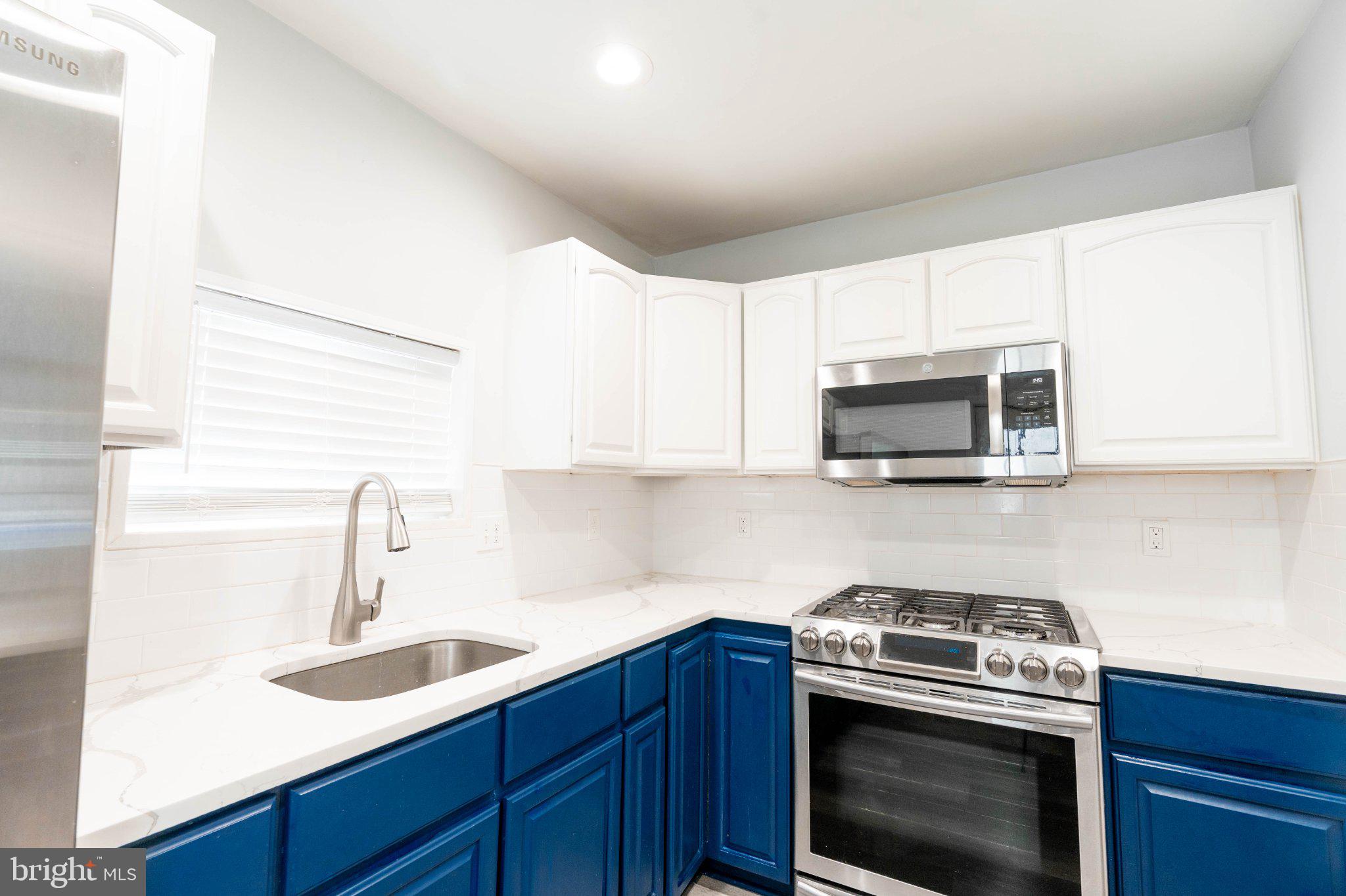 2433 South 3rd Street Philadelphia, PA 19148 - Photo 8 of 25 Modern kitchen with vibrant blue accents.