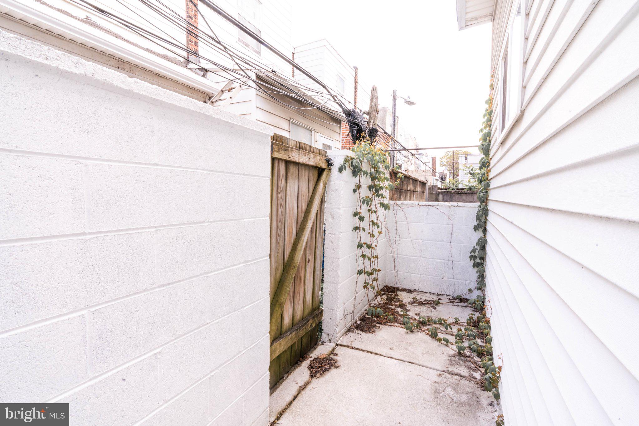 2433 South 3rd Street Philadelphia, PA 19148 - Photo 9 of 25 Narrow passageway with greenery.