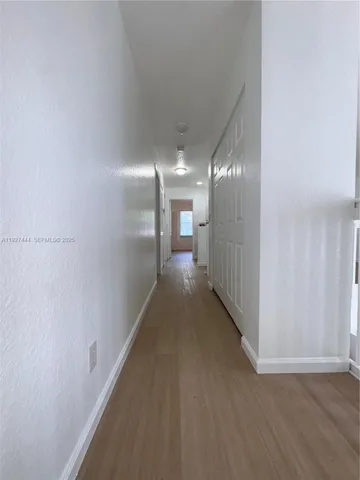 a bathroom with a granite countertop bathtub shower sink vanity and toilet