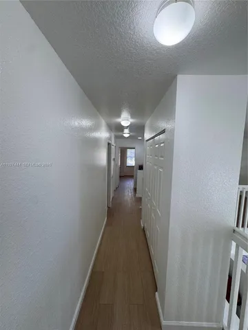 a view of an swimming pool with trees in the background