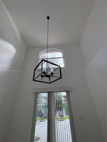 a view of a hallway with a chandelier