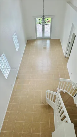 a view of an empty room with a rug