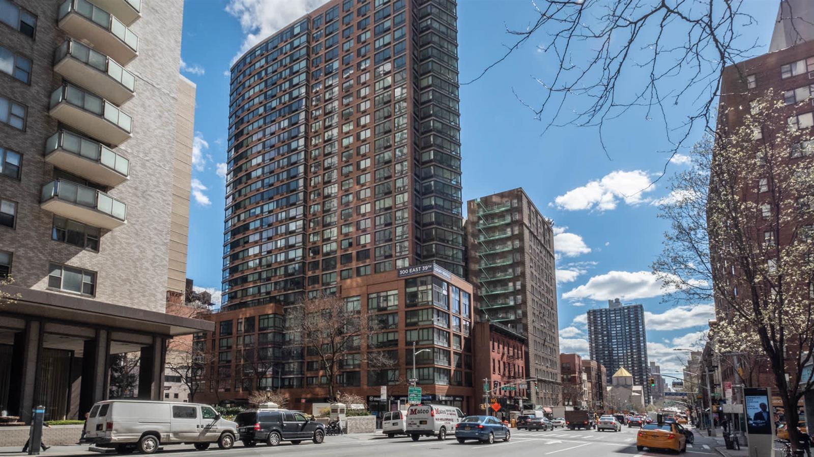 300 East 39th Street, Unit 21E Manhattan, NY 10016 - Photo 3 of 10 a city street lined with buildings and cars