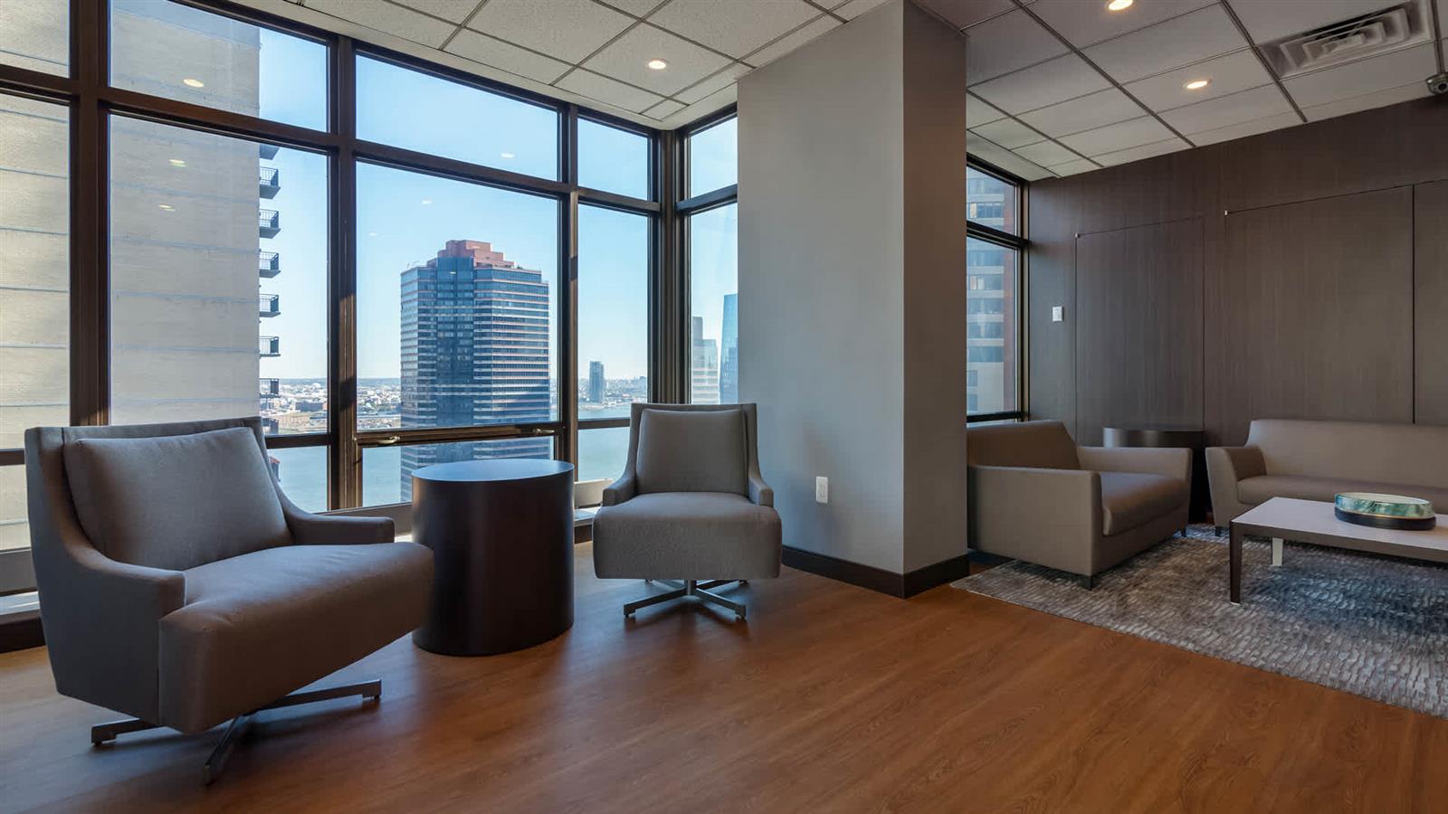 300 East 39th Street, Unit 21E Manhattan, NY 10016 - Photo 6 of 10 a living room with furniture and a floor to ceiling window