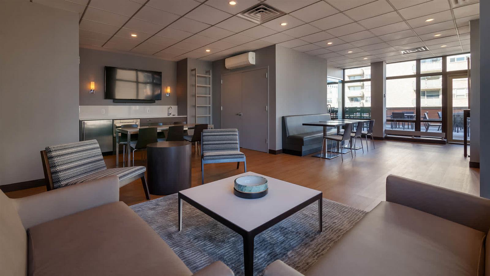 300 East 39th Street, Unit 21E Manhattan, NY 10016 - Photo 7 of 10 a living room with furniture a flat screen tv and a large window