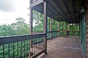 93 Bear Track Trail Morganton, GA 30560 - Photo 4 of 12 a view of a porch with a floor to ceiling window and wooden fence