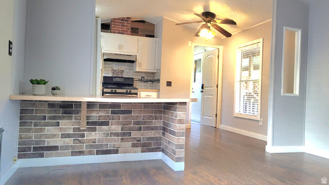 1525 South 400 East, Unit 63 Springville, UT 84663 - Photo 5 of 36 Kitchen with decorative backsplash, black stove, ceiling fan, light countertops, and white cabinetry