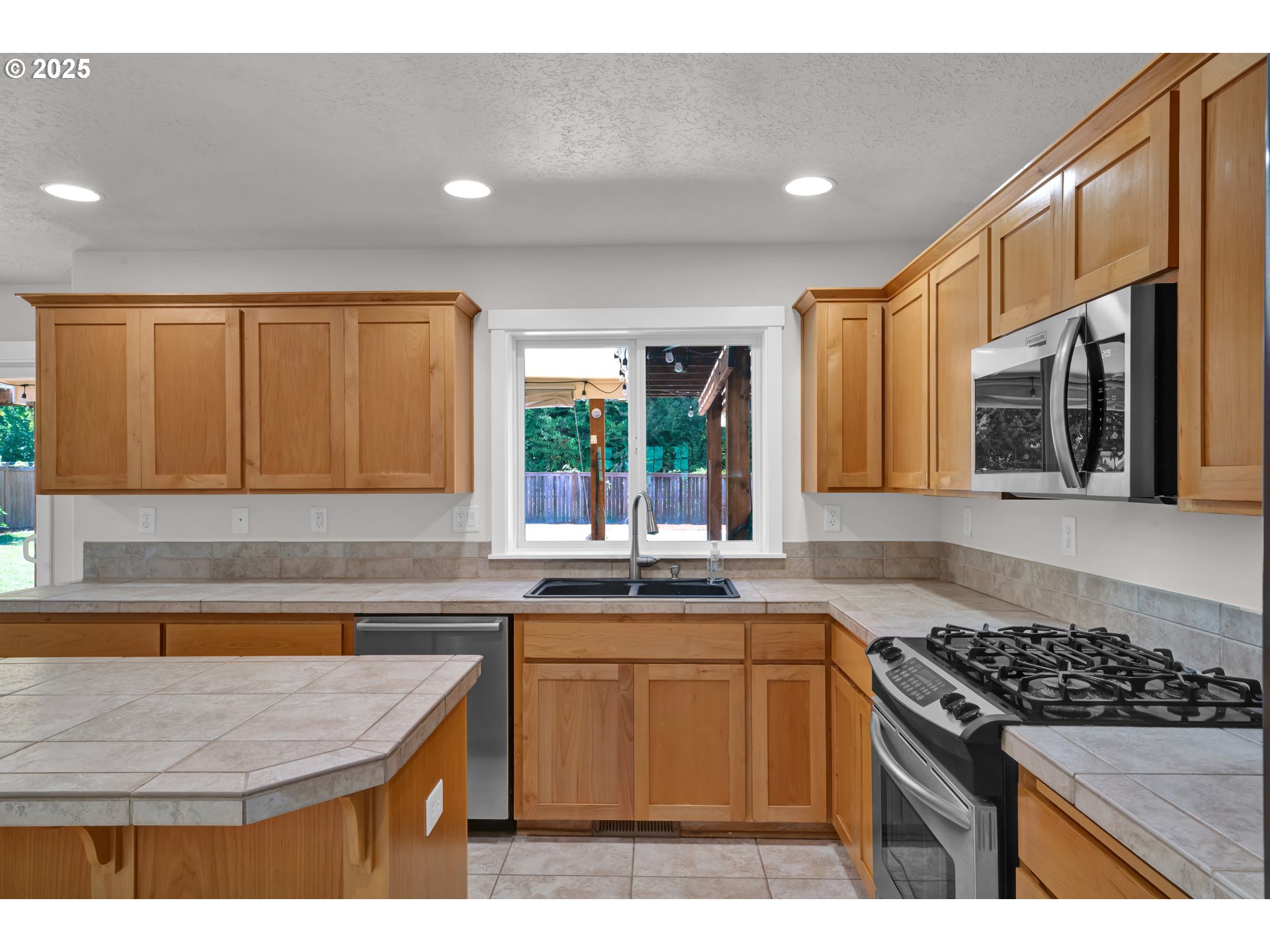 2310 Northwest Gale Street Albany, OR 97321 - Photo 7 of 48 a kitchen with stainless steel appliances granite countertop a stove a sink and a microwave