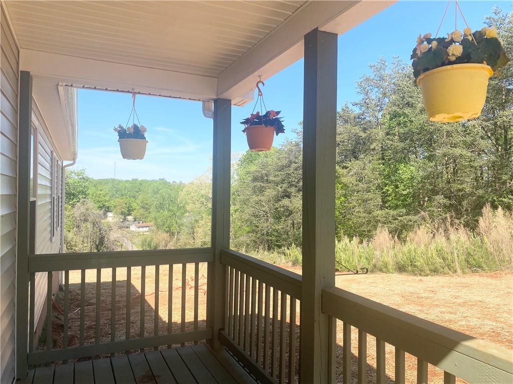 142 Burns Hill Street Liberty, SC 29657 - Photo 3 of 12 Enjoy outdoor living on this elevated porch with expansive views of natural surroundings.
