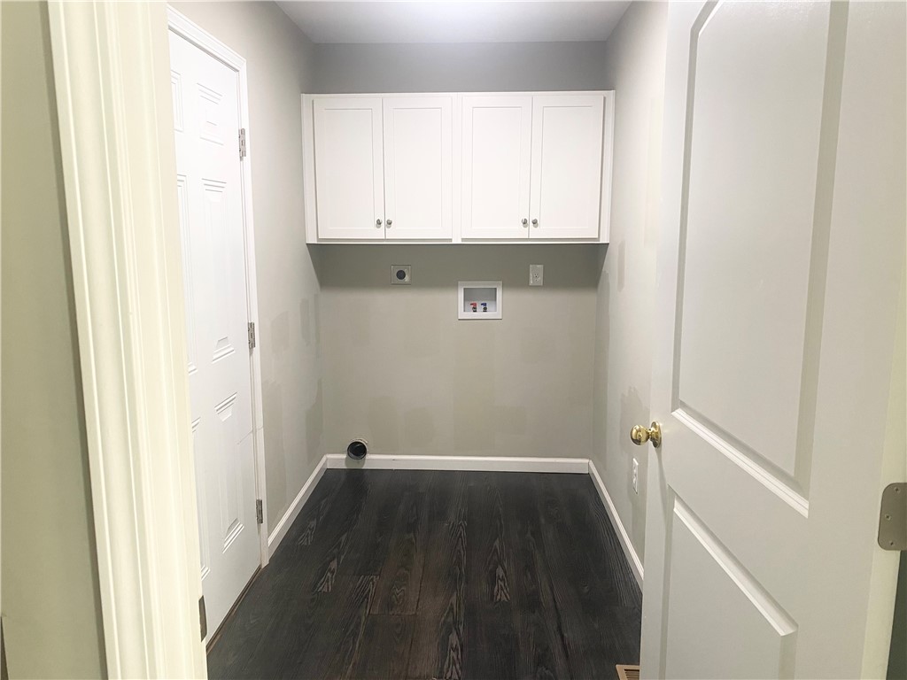 142 Burns Hill Street Liberty, SC 29657 - Photo 6 of 12 Functional laundry space featuring dark wood flooring and ample cabinetry for storage.