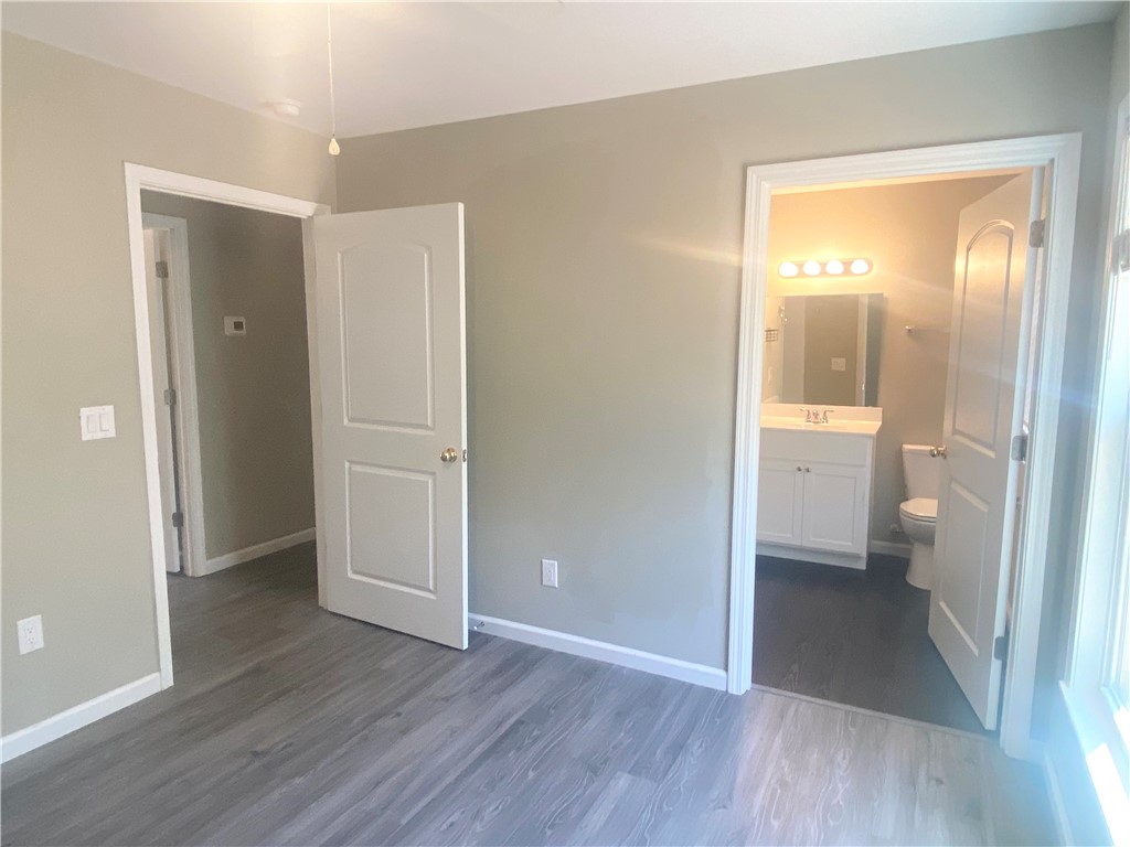 142 Burns Hill Street Liberty, SC 29657 - Photo 8 of 12 This bright space features sleek flooring and a clear pathway to a well-appointed bathroom.