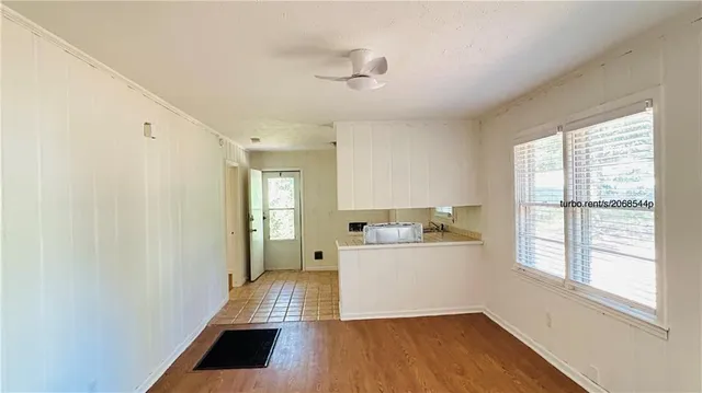 a room with a wooden floor and white walls