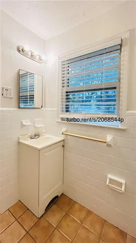 a view of kitchen with granite countertop cabinets and window