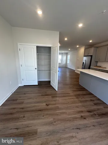 a view of a kitchen with wooden floor and a window