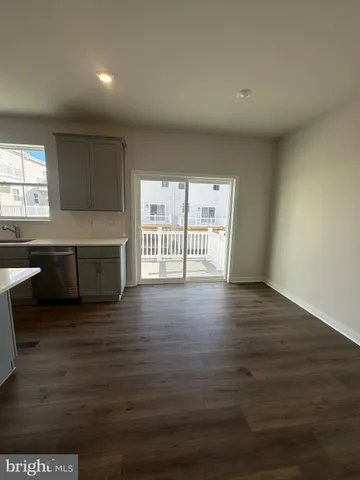 a kitchen with granite countertop a sink and a wooden floor
