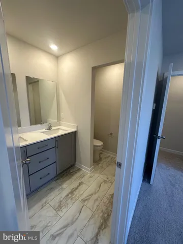 a bathroom with a shower sink and mirror