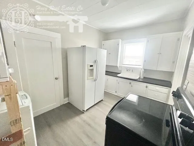 a kitchen with a refrigerator and a sink