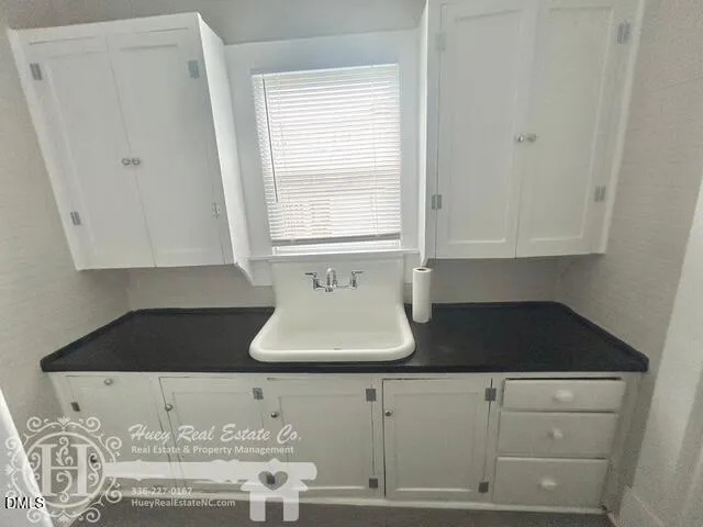 a kitchen with a sink a stove and a window