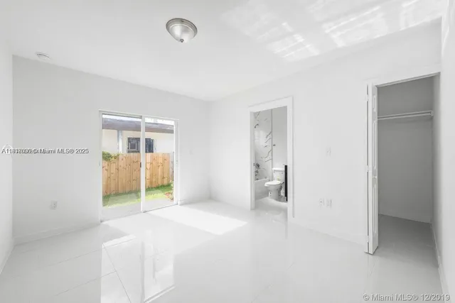 a bedroom with closet and windows