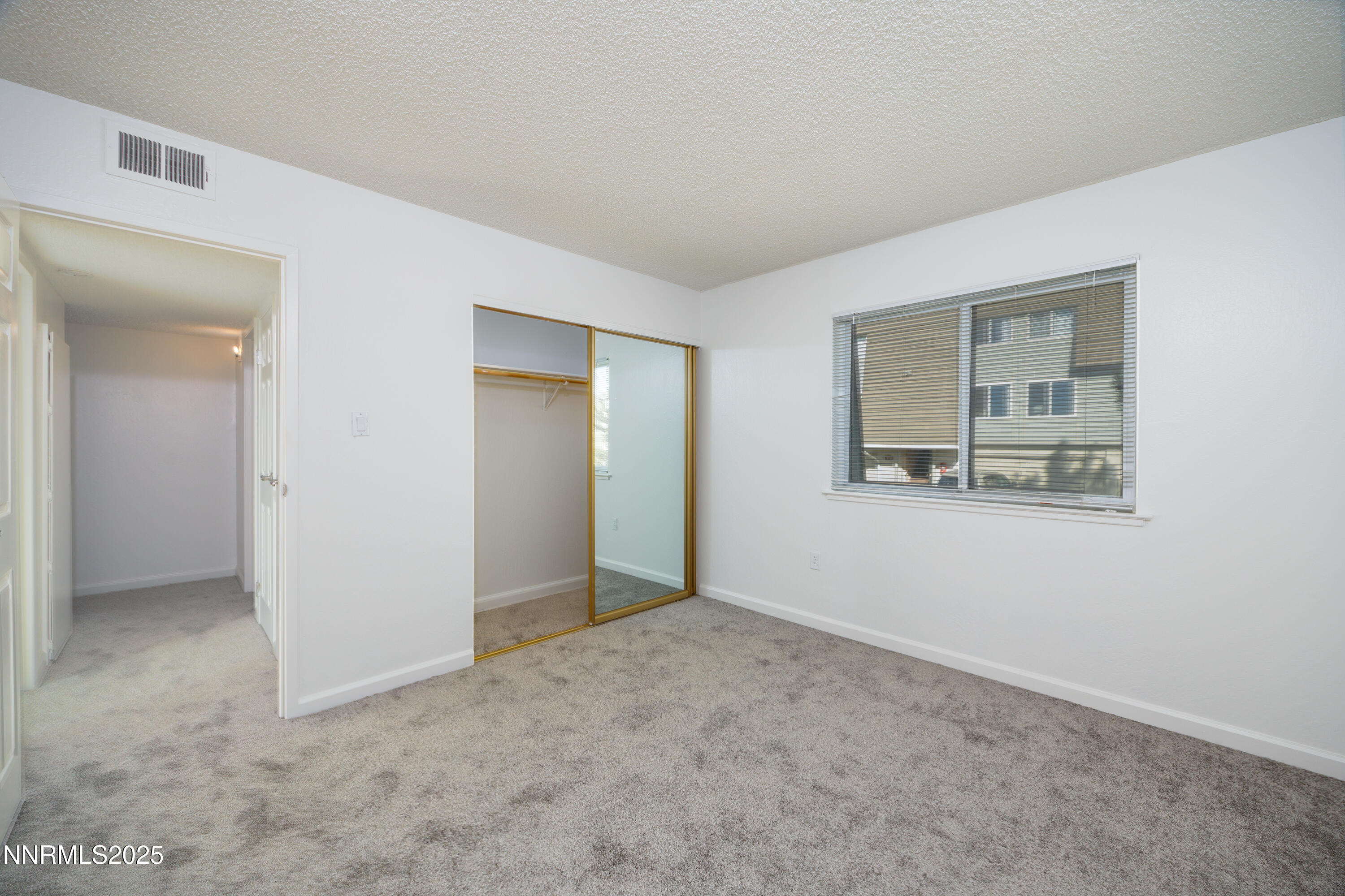 140 Griswold Way, Unit C Reno, NV 89503 - Photo 10 of 17 an empty room with windows and closet