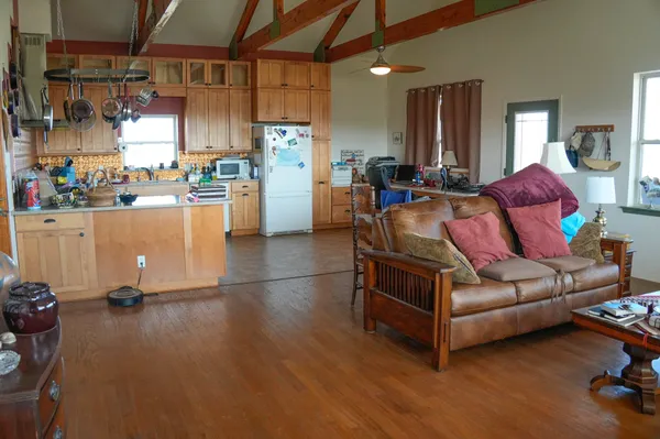a living room with furniture and kitchen view