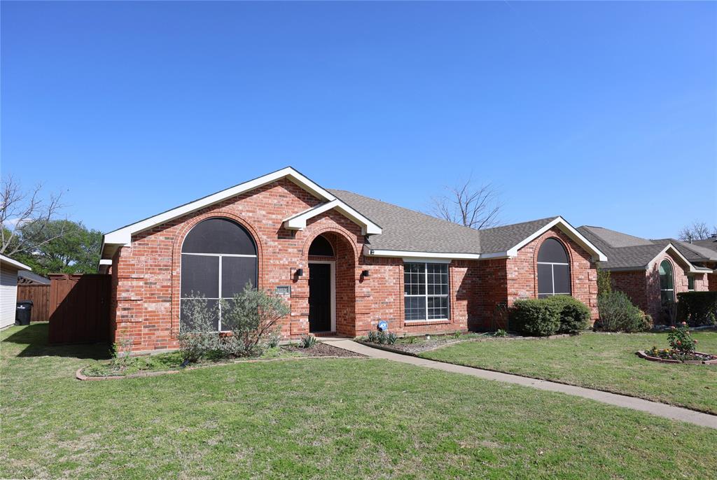 8112 Dock Street Frisco, TX 75035 - Photo 3 of 34 a front view of a house with a yard and garage