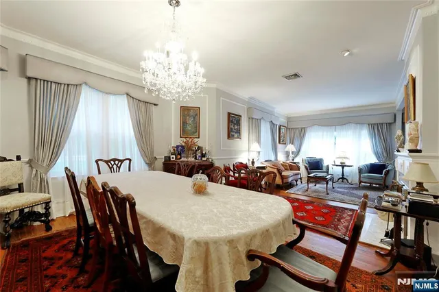 a view of a a dining room with furniture window and wooden floor