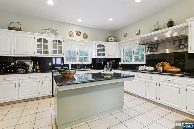 a kitchen with stainless steel appliances granite countertop a sink and cabinets