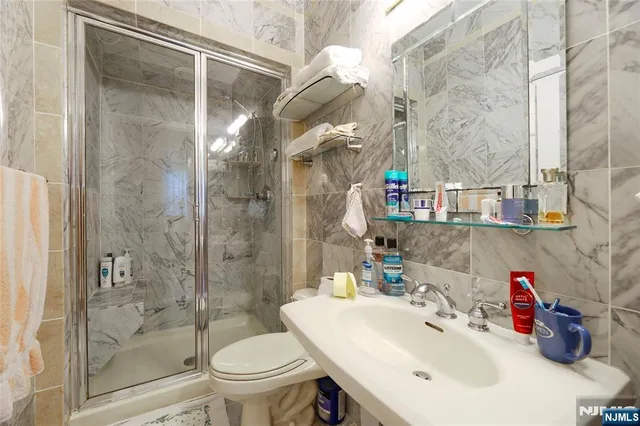 a bedroom with bed and a chandelier