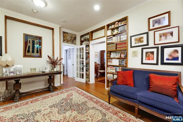 a living room with furniture a rug and a table
