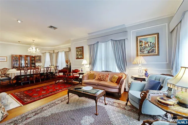 a living room with furniture a rug and a window