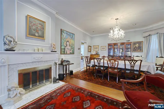 a living room with furniture a chandelier and a fireplace