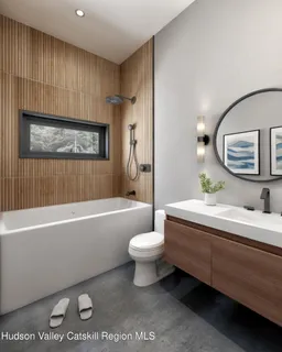 a bathroom with a toilet a sink a mirror and bathtub