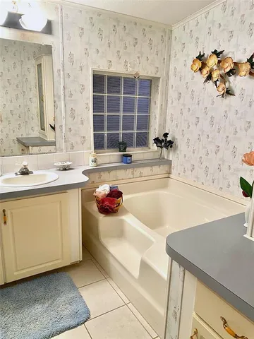 a bathroom with a tub sink and a mirror