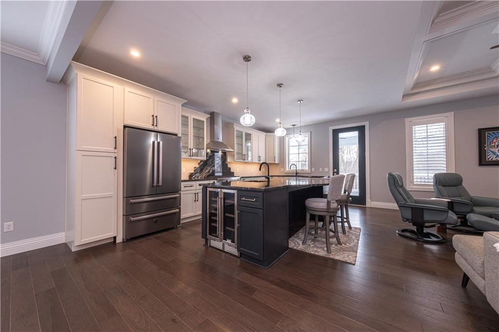 1213 Harrison Court Export, PA 15632 - Photo 11 of 41 a kitchen with stainless steel appliances kitchen island granite countertop a refrigerator a stove a sink dishwasher a dining table and chairs with wooden floor