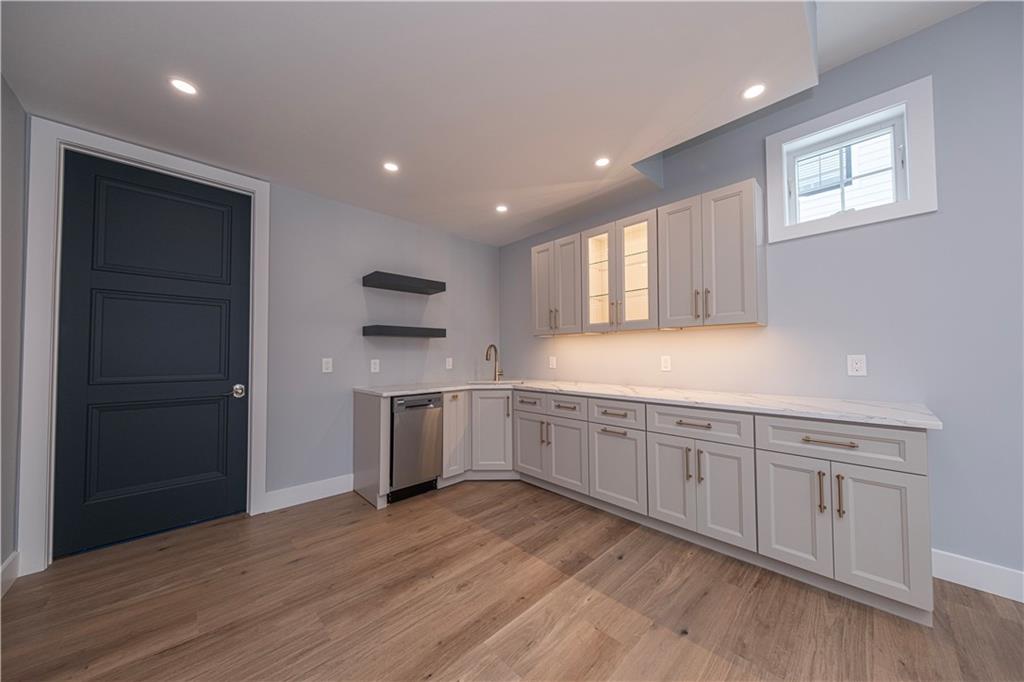 1213 Harrison Court Export, PA 15632 - Photo 33 of 41 a kitchen with white cabinets with wooden floor and window